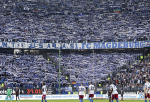 Mehr über den Artikel erfahren „Luft nach oben“: Magdeburg-Fans rufen zur Fahrt zum KSC auf